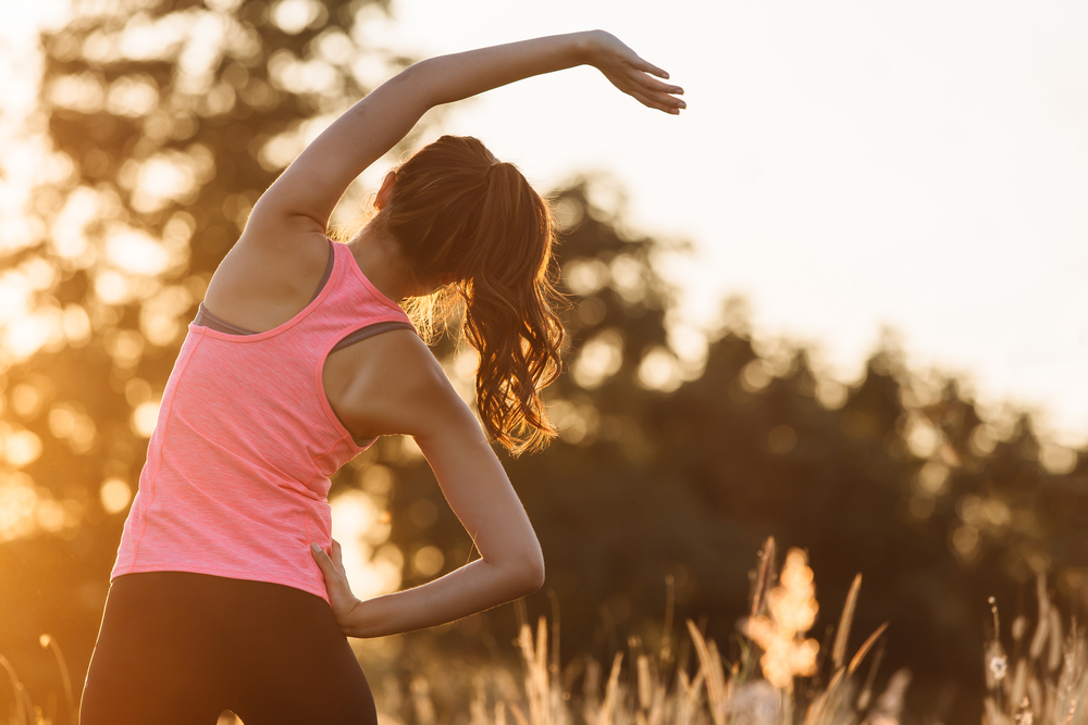 Young female workout before fitness training session at the park.jpg